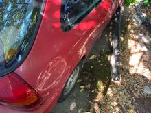 Where the dents start in the rear on the passenger side.