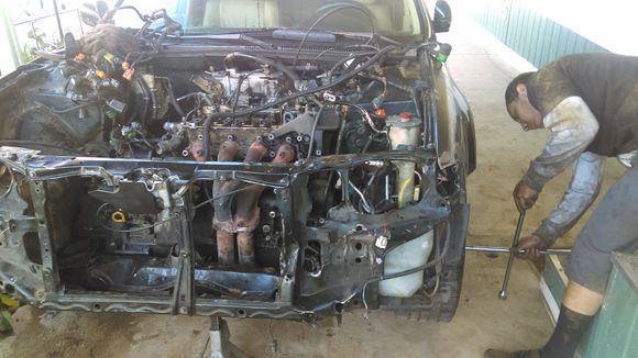 1st day work. 
We already removed headers and harness from the engine. Also unbolted the flywheel bolts under the car to allow for seperation of the motor and transmission.