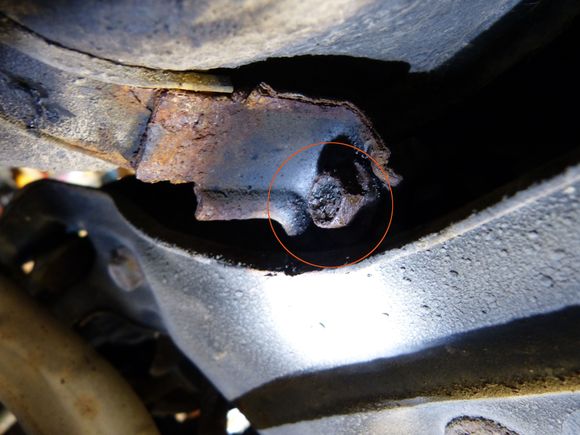 There's definitely clearance to put a socket on this bolt, but the bolt seems to just spin and seems like the bracket is going to break right off. There is an excess of bolt length of about 1 inch on the other side of the bracket (not visible in this image).