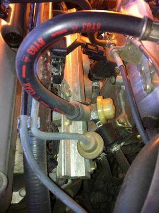 backside view from right looking at rail and intake plenum on right, valve cover on left