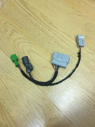 Ignore the small light grey plug. 

The dark grey plug goes to and from the starter relay

The green plug goes to the clutch switches.

And the large light grey connector hooks up to the connector under the center console.