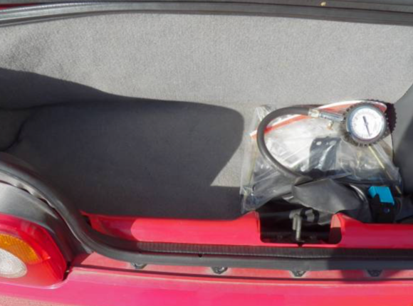 Trunk has tool kit still, excellent shape, car still has OEM SPARE TIRE up front and jack as well.   Convertible leather cover also still with car.