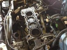 nice little shot of my D15B without it's head, why? A bolt came loose from the lower timing cover and got sucked into the timing cover and tore the timing belt apart, causing the pistons to bend the valves for cylinders 2 and 3, thus the head was sent out to be completely rebuilt.