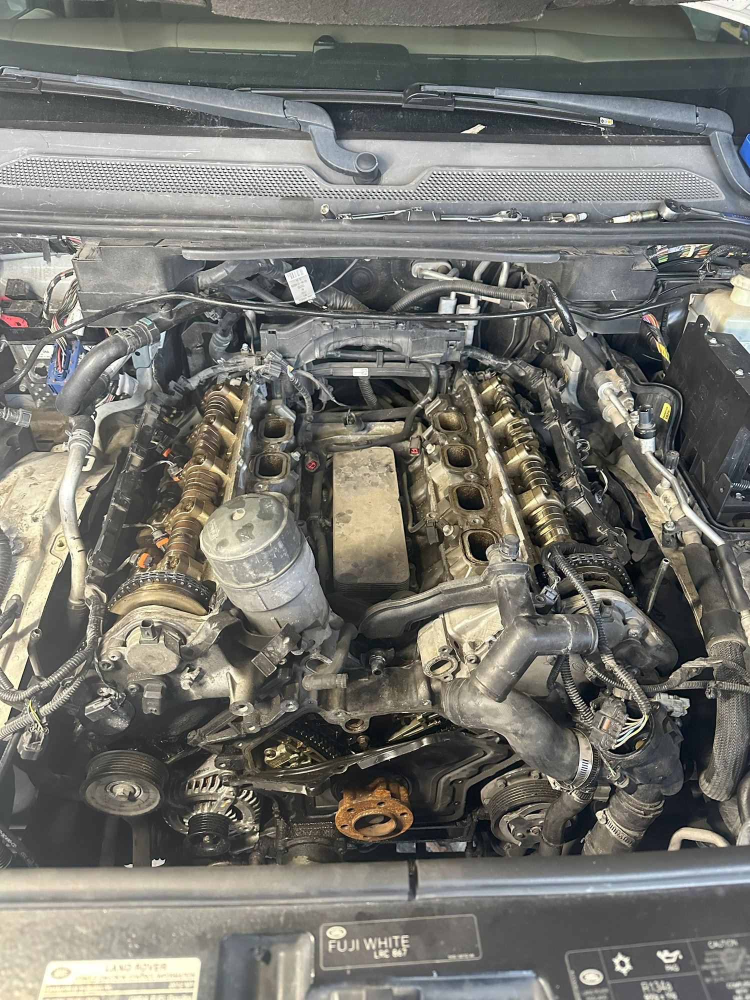 The beginning of the tear down. The previous owner bent the timing cover to look inside vs taking the crank pulley off