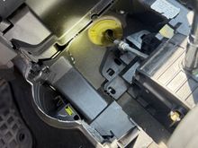 Once the cover is removed, showing the cable from the shifter, the clip, and the route through the plastic bulkhead