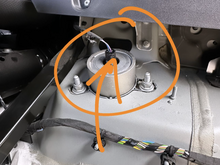 The metal bit below the wiring / plug in the center is what moves up and down; and causing the rattle. Only moves when in rough road; leading me to think it’s adaptive dampening / suspension.  