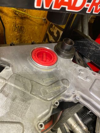 The red plastic piece works to both press the seal to its proper depth, and it keeps the inner diameter PTFE seal expanded until installation.  I learned that these PTFE seals must be installed dry.  Do not oil the seal for install.