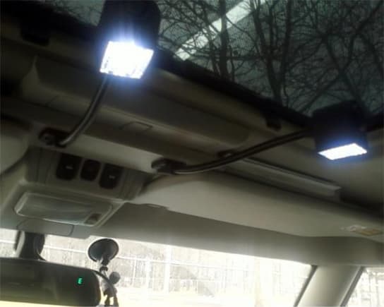 I made aluminum plate to hold the gooseneck lights and connected the mains to the original cabin light terminals. Extra space for the CB radio mount.