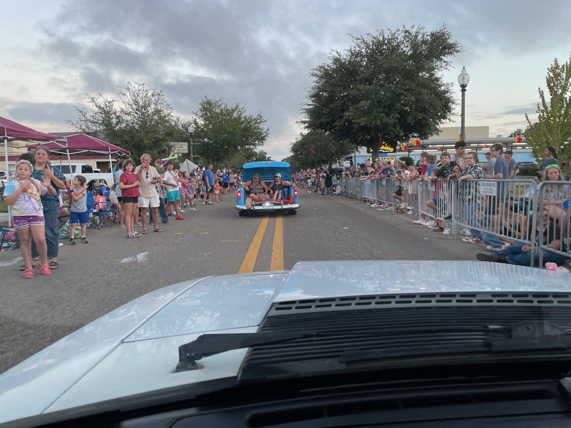 Lots and lots of people lining the streets to watch the cars go by.  So many Mardi Gras beads thrown as well as candy and stuffed animals by the cruisers. 