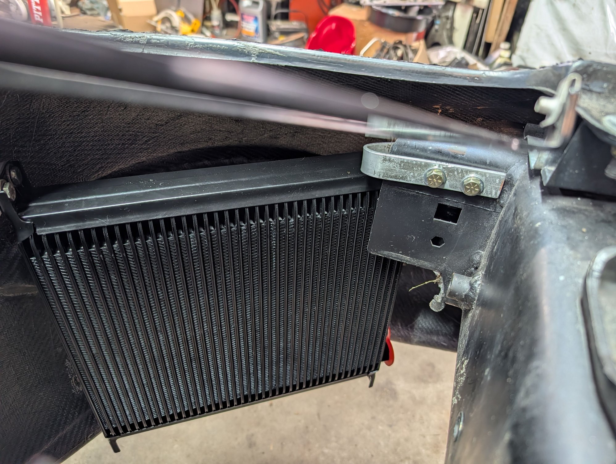 I also made brackets for a larger oil cooler. It fits inside the bumper behind the brake duct opening.
