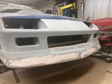 The headlight support is bonded to the front bumper 