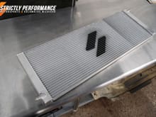 Our custom heat exchanger fits perfectly in the radiator and provides way more cooling area.