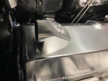 The fitting has baffling within it as a first point of oil catch.