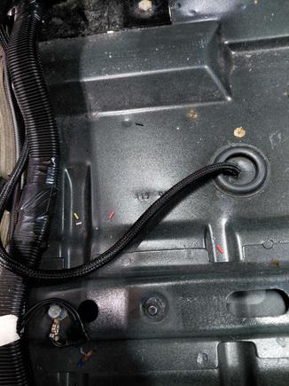 MRW FF Sensor harness going through floor grommet under drivers seat.