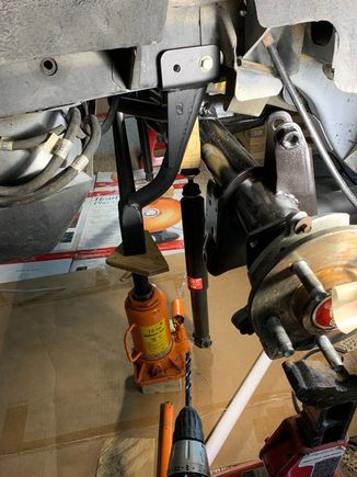 Check out my mechanical helpers holding up the PHB!  In the youtube video, Eric talks about holding this bar up firmly against the frame.  I used the gas charged shocks that came out of the coupe to hold this bar up against the frame.  Its what you've gotta do when you're the last guy on earth that works on cars!
