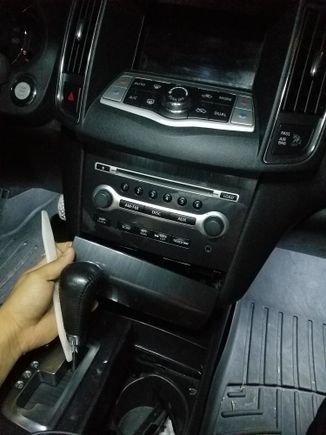 Removal of a 2014 nissan maxima stereo without bose system.... Use trim stick to remove panel under stereo and panel with vents above stereo. Disconnect the 3 harnesses connected to a/c unit. Stereo will have philips screws holding it in place.