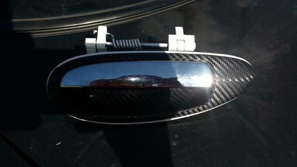 4th Gen Maxima black carbon fiber vinyl wrapped door handle with white spray painted edges