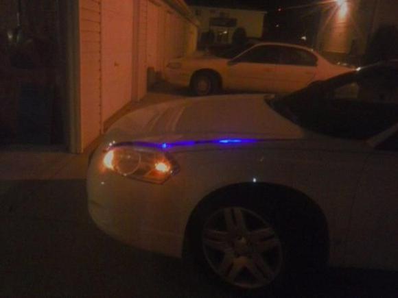 Hood popped, but not open. At night (Driver)