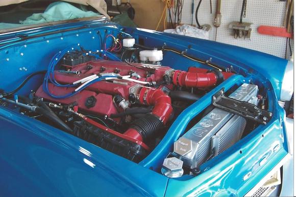 Yea! That huge red red blob is a "96 Gen 2 Viper! ECU was popped for 500 hp and 500 fpt. It fit after the old huge old heater fan, radiator and housing went. You can see the outline in the bolt pattern on the firewall. Radiator was moved to  the front side of the core support and water pump inlet was cut and turned.