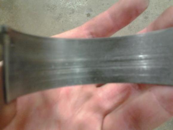 Rod bearing damage, most likely from too little piston to wall clearance.