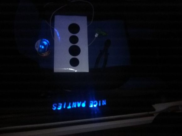 Custom LED door sill. Drivers side says Mustang. Wired into dome light. The circles are vynal for my custom LED cup holders