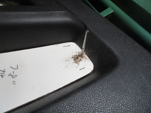I used extra drill bits to register the location of the Masonite over the door panel insert area