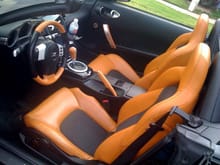 My interior....Custom wrapped steering wheel, shift knob, e-brake, and passenger handle.  Aesthetically pleasing, not going overboard with the orange.  Thus, my selection of pieces were limited.

Kenwood DNX8120 head unit.  Infinity Kappa tweeters in doors.