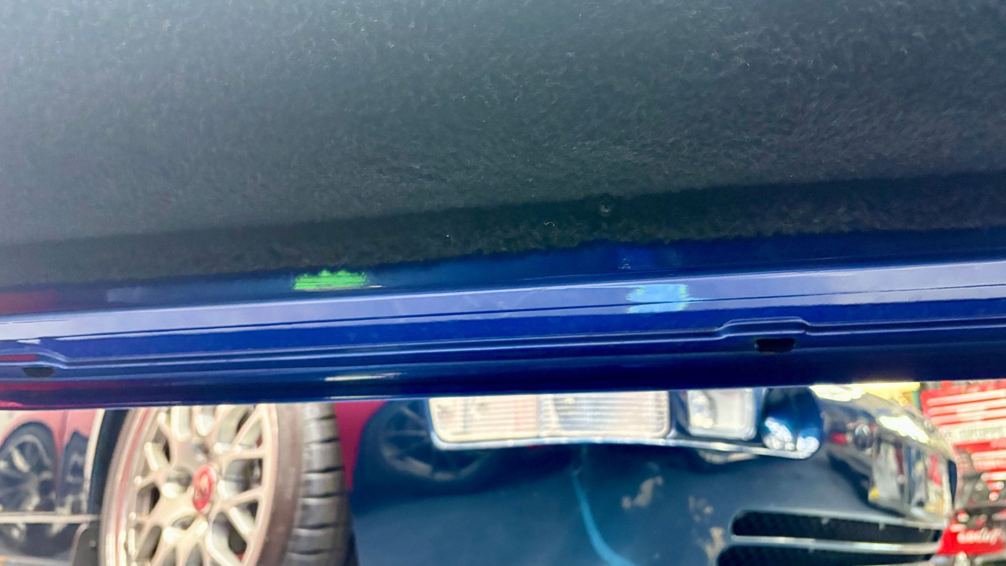 Outer skin paint color is identical to the underside of the door vs what appears to be a different shade on the white car. 