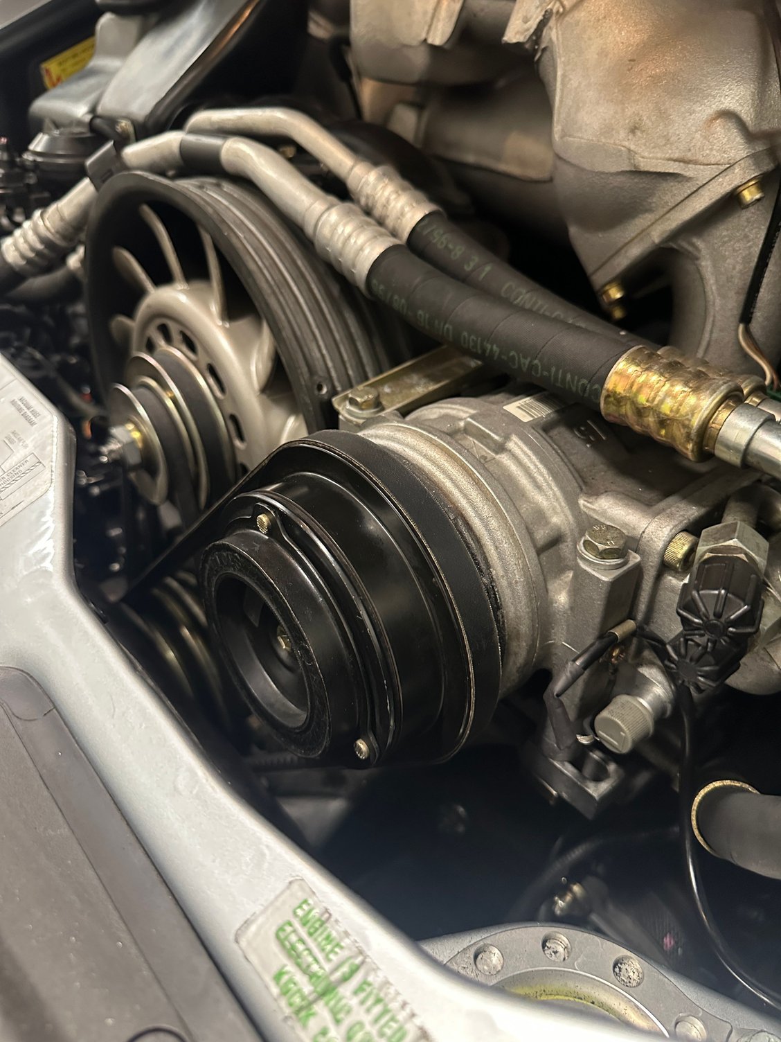 The compressor, with a new belt installed, but missing its electromagnet wires.