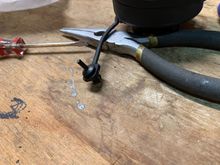 Reinstall expansion rivet in new cap tether. 