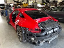 This was the 1st photo and it freaked me out since there was NO damage to the rear of the car!  They removed all of these parts to get a perfect Guards Red paint job throughout.