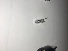 New bulb has simple wire prongs.