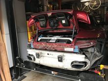 rear-rear fender liner removed. jack up the car to give yourself space between the tire and liner to remove the screws holding the liner. remove tail lights. Remove bumper cover which requires removal of several screws and one electrical connector to the license plate light.
