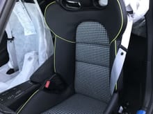 Custom tailored LWB seats in black leather with acid green piping (instead of stitching) and black/silver houndstooth inserts.