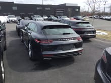 Rear of 2018 Panamera 4 Sport Turismo; just behind it to the right is the Panamera Turbo ST