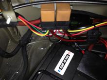 The relays I used are mounted behind a plastic removable panel that sits in front of the battery in the frunk.