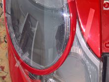 Reattach with tape. Any area that seems to not want to lay flat against headlight make a few passes over with heat gun on LOW. Press area against headlight spray with cold water. It should stay where you pressed it. When satisfied remove sand and paint as wanted. 
Thanks