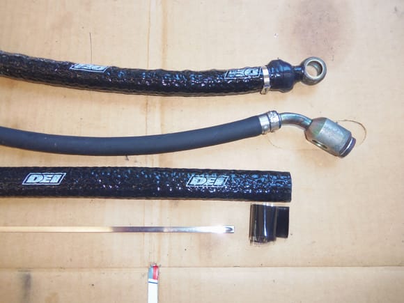 Crimped hose, double clamps, firesleeve, firetape, and zip ties.