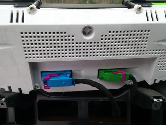 Once the top of the pod is off, you simply pull the instrument cluster forward. On the back are two super easy connectors. Rotate the pink lever away from the wire, then they pull straight away from the back of the cluster. The blue one is open, the green one is closed.