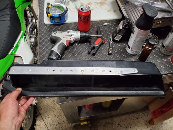 The Driver's side parcel tray was badly warped and the mounting holes were broken so I riveted an aluminum bar to it to straighten it out and drilled new mounting holes in the aluminum. Also added a new door side bracket to replace the piece of strapping that was used before.