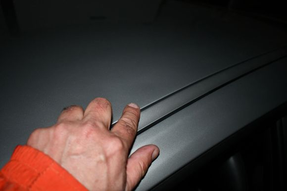 This is my fault!  Minor indentations above driver door from lifting my big butt in and out of the car inside the trailer.