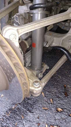 Near bolt on control arm - remove to remove shock bolt - put jack under edge of shock under shock bolt - this is for 997.2 and not 997.1