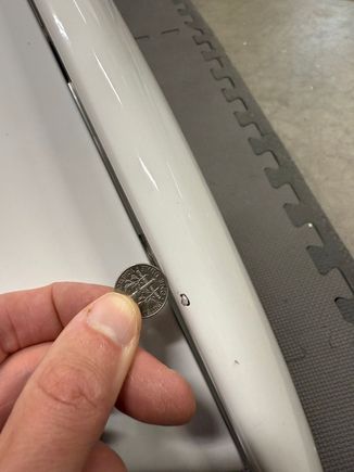 Chip on top of wing-end (driver side), dime for scale