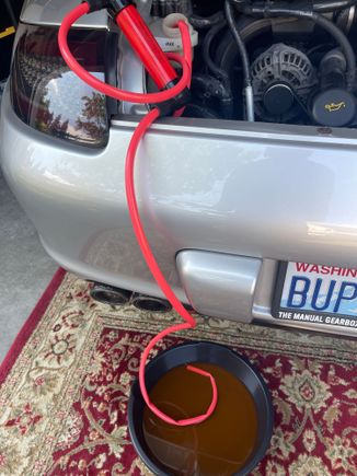 Hand-pump siphon removing old coolant 