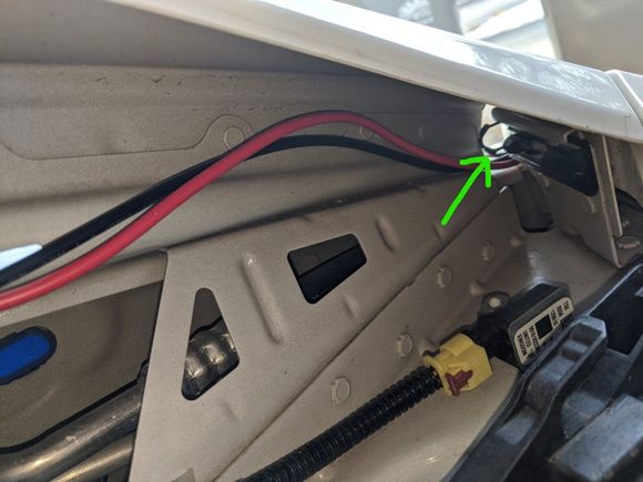 green arrow points at clip. you don't have to remove it just pull it out of the way.