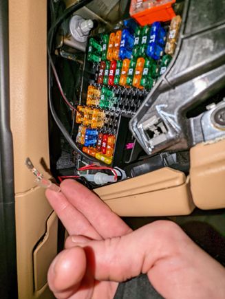 Slightly cut the hardwire blade down to match a fuse blade size, then it fit perfectly into an empty open fuse slot. See this for wiring diagram: https://www.autogenius.info/porsche-cayenne-2011-2017-fuse-box-diagram/ 