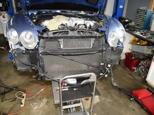 Lifting the radiator assembly into place. It was a little tricky getting all those quick connect radiator hoses to actually click into place