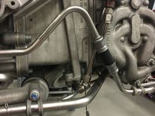 I have more pictures of this tha tI'm trying to dig up, but the exhaust pressure sensor is installed behind the dampening chamber in order to protect the sensor from super hot exhaust gas and even out the readings from individual pulses. It is plumbed via tubing up the side of the head and installed there for access to it while the engine is in the car.