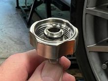 Drain valve activator cap. Screwing this cap onto the valve body opens the valve to start oil flowing through the attached drain tube.