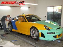 Yellow 911 GT3 RSR being transformed in to the Falken Tire race colors.